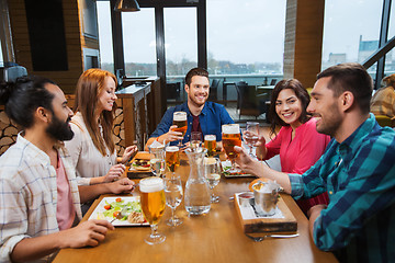 Image showing friends dining and drinking beer at restaurant