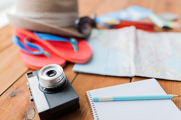 Image showing close up of camera, notepad and travel stuff