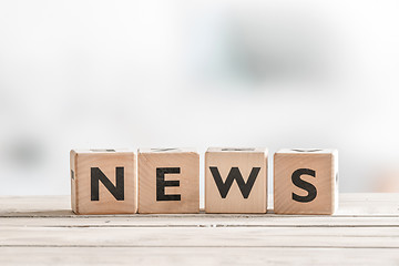 Image showing Wooden news sign on a table