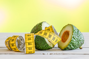 Image showing Avocado with yellow measure tape