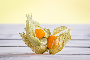 Image showing Cape gooseberries on a wooden desk