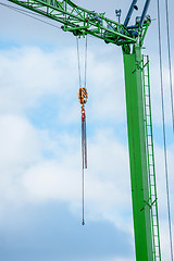 Image showing Green crane with a chain