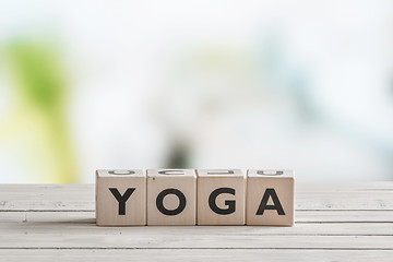 Image showing Yoga sign on a wooden desk