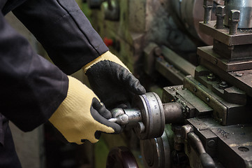 Image showing worker in protective gloves