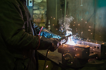 Image showing worker welding metal