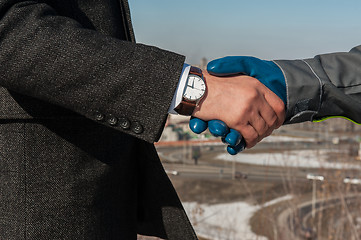 Image showing worker shakes hands with businessman