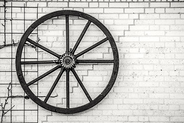 Image showing Old wheel hanging on a wall