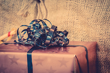 Image showing Shiny Xmas gifts with blue ribbon