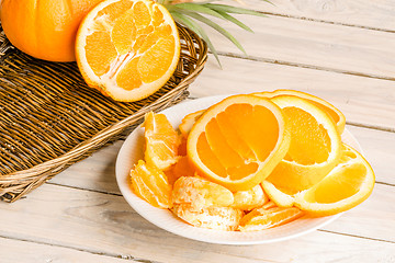 Image showing Orange fruit dish on a wooden table