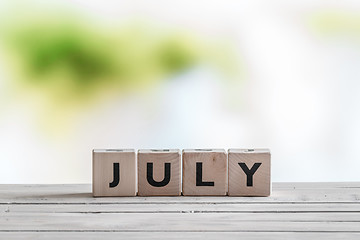 Image showing July sign on a wooden table