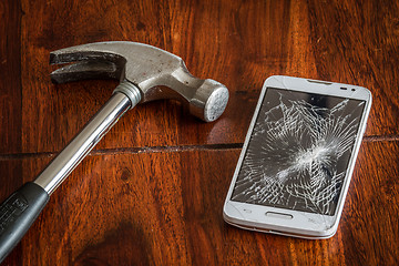 Image showing Smashed phone screen on a table