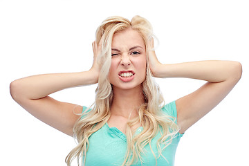 Image showing young woman holding to her head and screaming