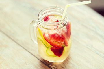 Image showing close up of fruit water in glass bottle