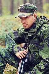 Image showing young soldier or hunter with gun in forest