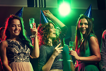 Image showing smiling friends with glasses of champagne in club