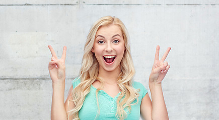 Image showing smiling young woman or teenage girl showing peace