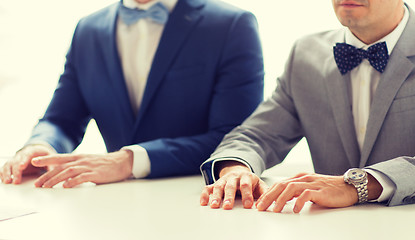 Image showing close up of happy male gay couple hands on wedding