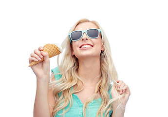 Image showing happy young woman in sunglasses eating ice cream