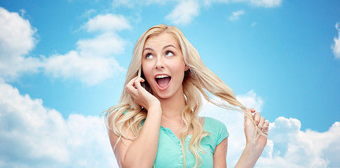 Image showing smiling young woman calling on smartphone