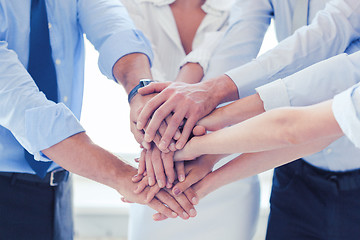 Image showing business team celebrating victory in office