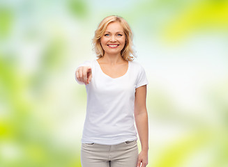 Image showing smiling woman in white t-shirt pointing to you