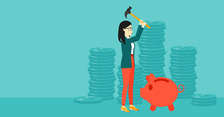 Image showing Woman breaking piggy bank.