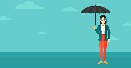 Image showing Business woman standing with umbrella.