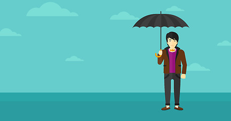 Image showing Businessman standing with umbrella.