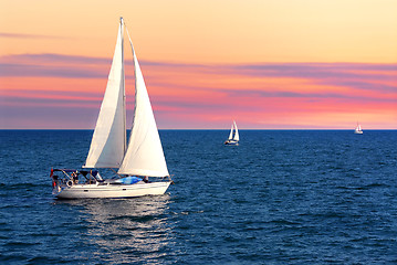 Image showing Sailboats at sunset