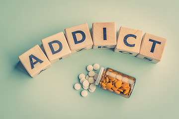 Image showing The word addict on a table