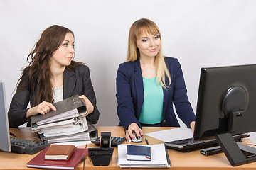 Image showing Office employee asks for help from colleagues at work with papers and documents