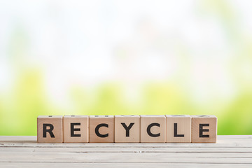 Image showing Recycle sign on a wooden table