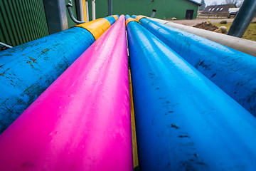 Image showing Colorful pipes at a farm