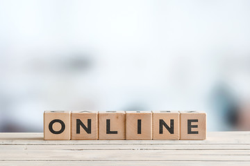 Image showing Online sign on a wooden desk