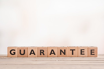 Image showing Guarantee sign on a wooden desk