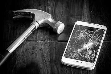 Image showing Broken smartphone and a hammer