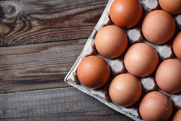 Image showing Brown eggs on a rustic wooden table