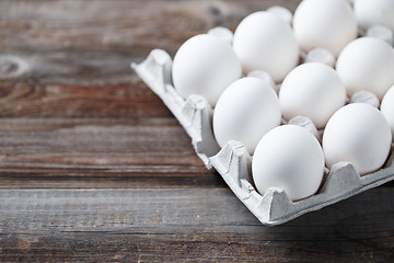 Image showing White chicken eggs on old wooden table