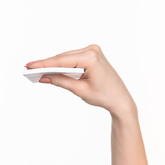 Image showing Female hand holding blank paper for records on white.