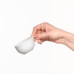 Image showing Woman hand with cup on white background