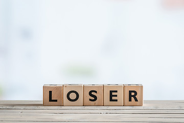 Image showing Loser sign on a wooden desk