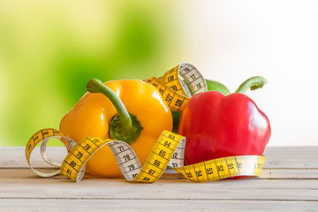 Image showing Pepper with measure tape on a wooden table