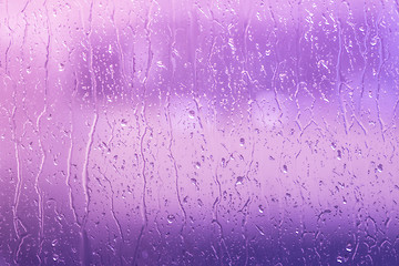 Image showing Rain on a window in purple colors