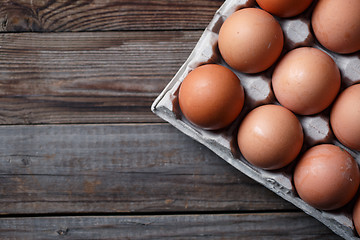 Image showing Brown eggs on a rustic wooden table