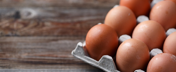 Image showing Brown eggs on a rustic wooden table