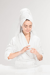 Image showing Woman cleaning face in bathroom