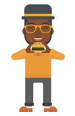 Image showing Man eating hamburger. 