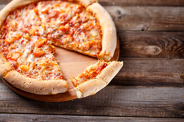 Image showing Delicious italian pizza with one eating piece