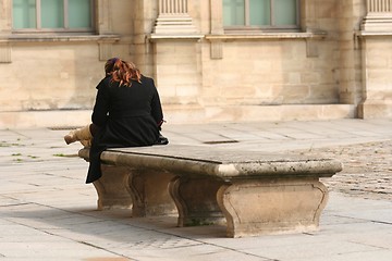Image showing Young woman on a bench