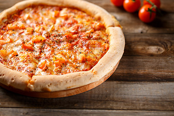 Image showing Tasty pizza on old wooden table.